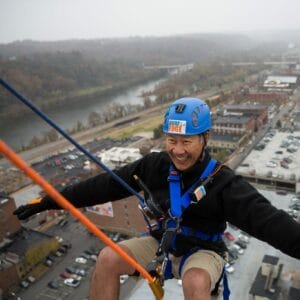 Man belaying off a building for over the edge fundraiser
