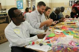 Men and women work on crafts together